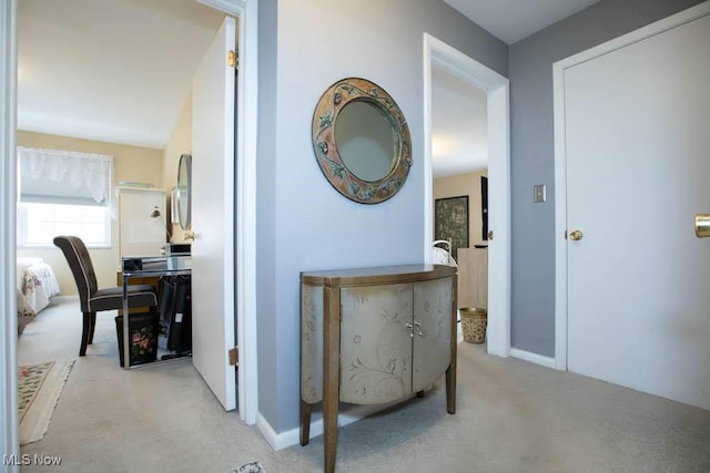 hallway featuring light colored carpet