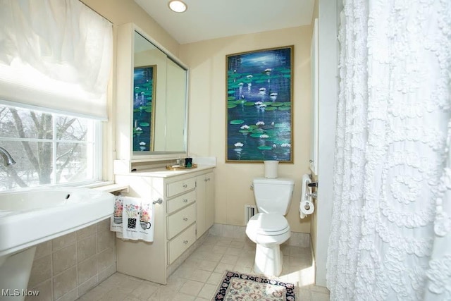 bathroom with vanity, toilet, and tile patterned floors