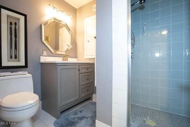 bathroom with tile patterned flooring, toilet, vanity, and a shower stall