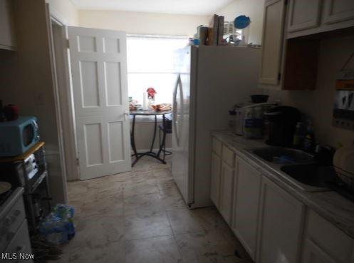 kitchen featuring stainless steel microwave and a sink