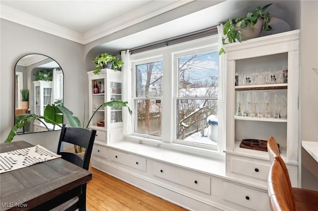 office area featuring light wood finished floors and crown molding