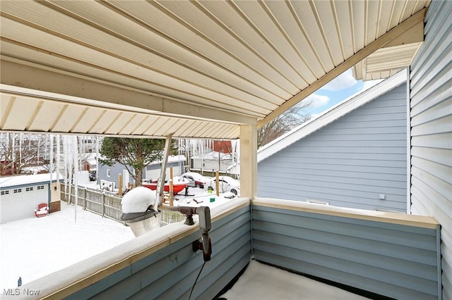 view of snow covered back of property