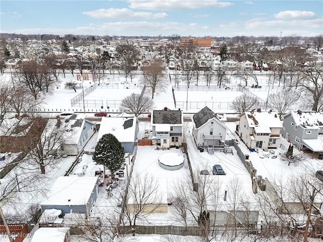 snowy aerial view with a residential view