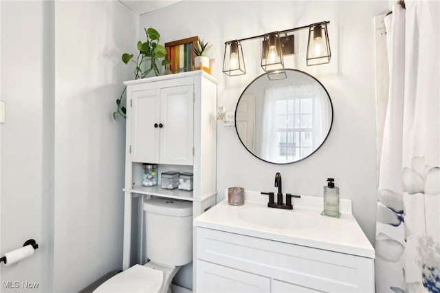 bathroom featuring vanity and toilet