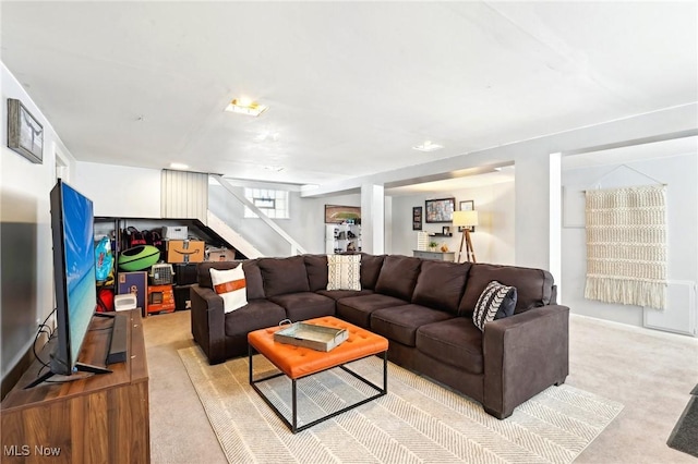 living room featuring light carpet and stairway