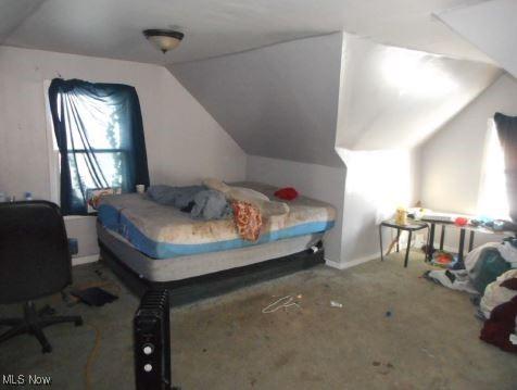 bedroom with carpet and vaulted ceiling