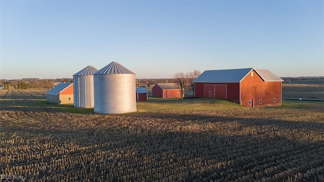 view of outbuilding with an outbuilding, driveway, and a rural view