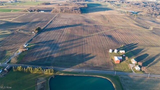 birds eye view of property with a rural view and a water view