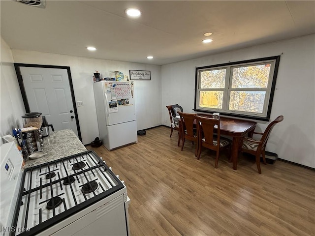 kitchen featuring white appliances, light wood-style flooring, visible vents, and recessed lighting