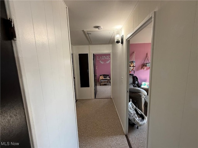 hallway with carpet flooring and attic access