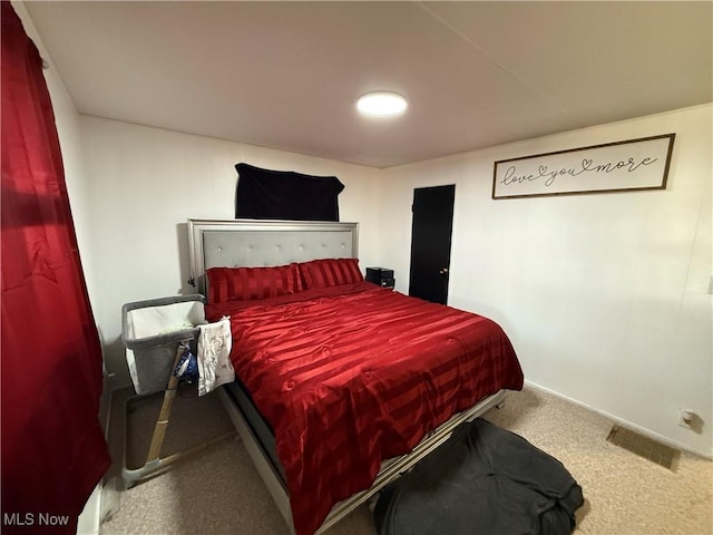 bedroom with carpet floors, baseboards, and visible vents