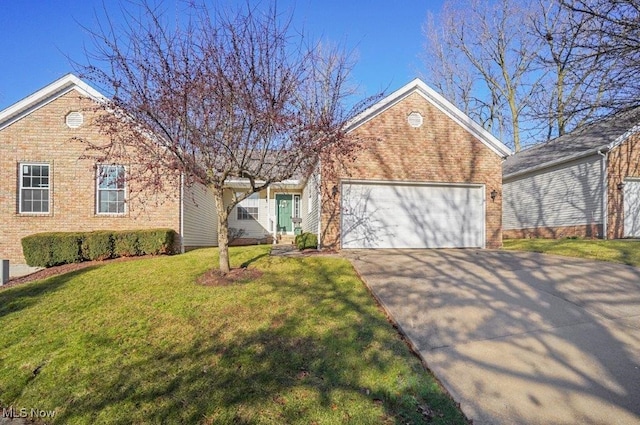 view of front of house with a front yard, brick siding, driveway, and an attached garage