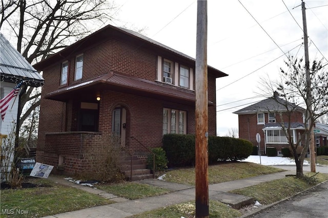 view of front facade with metal roof and brick siding