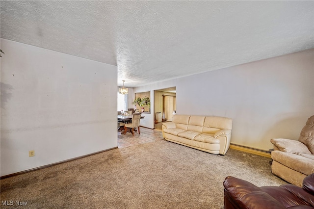 living area featuring light carpet, baseboards, baseboard heating, and a textured ceiling