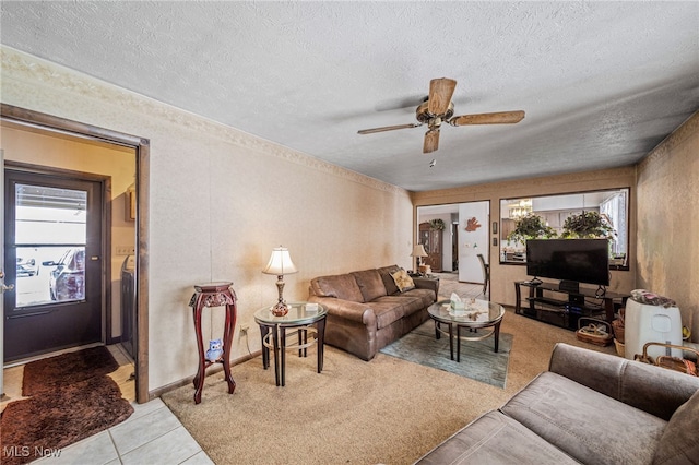 living area with a textured ceiling, light tile patterned flooring, and a ceiling fan