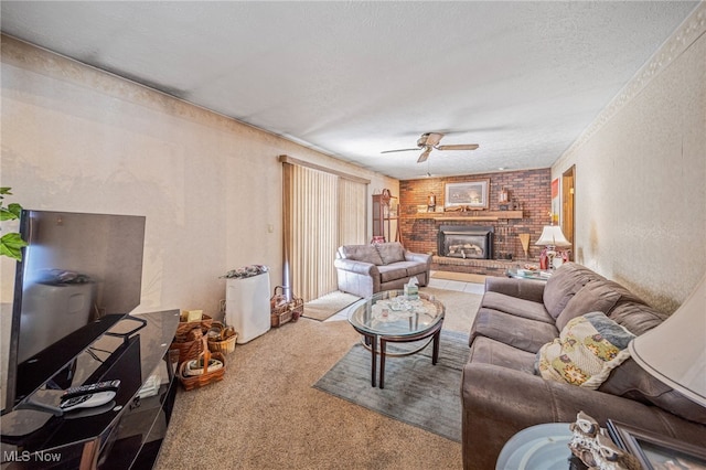 living room featuring carpet floors, a fireplace, a textured wall, a ceiling fan, and a textured ceiling