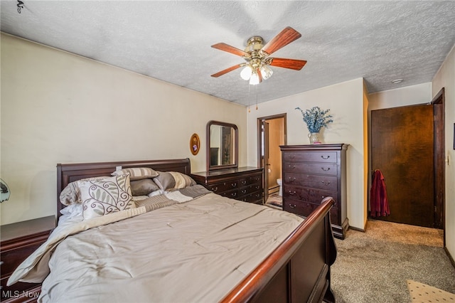 bedroom with a textured ceiling, a ceiling fan, and light colored carpet