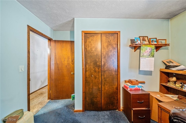 bedroom with a textured ceiling, a closet, baseboards, and carpet flooring