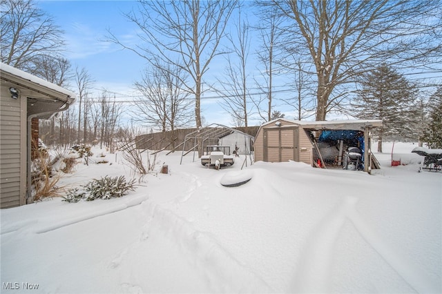 snowy yard with an outbuilding