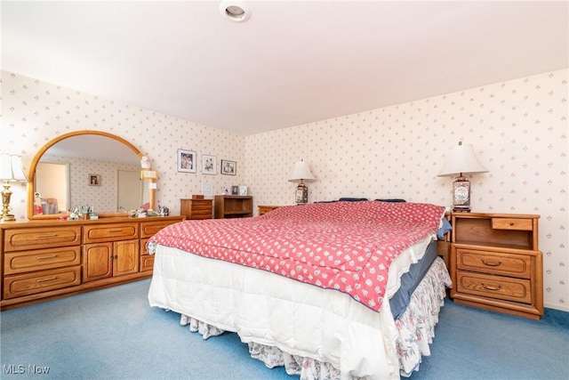 carpeted bedroom with baseboards and wallpapered walls