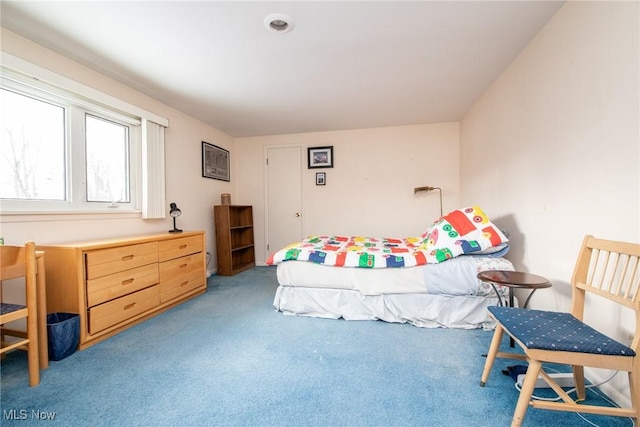 bedroom featuring light colored carpet