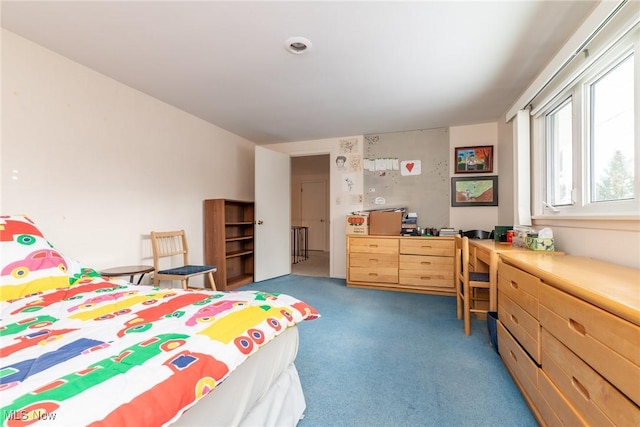 bedroom with dark colored carpet