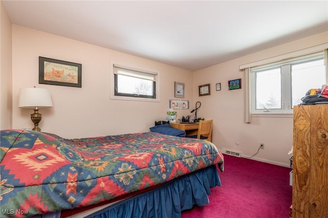 bedroom featuring multiple windows, carpet flooring, visible vents, and baseboards