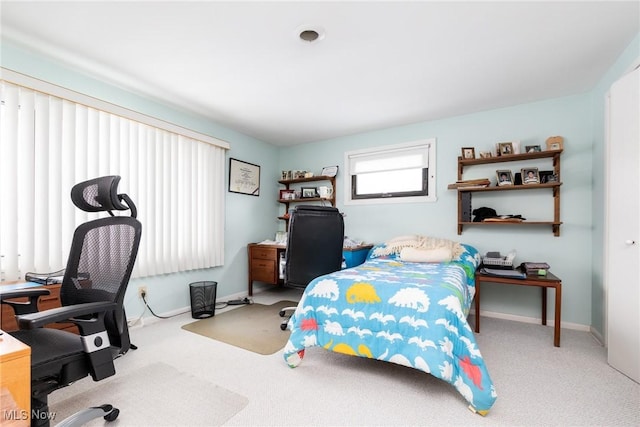 bedroom with light carpet and baseboards