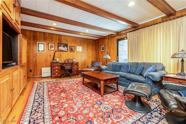 living room featuring light wood-style flooring, beam ceiling, and wooden walls