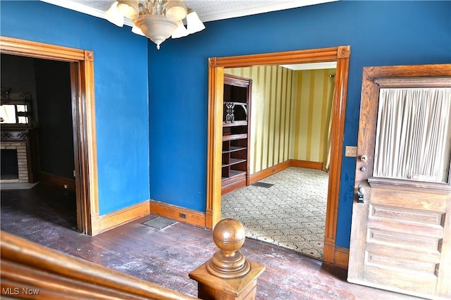 interior space featuring a fireplace, baseboards, and an inviting chandelier