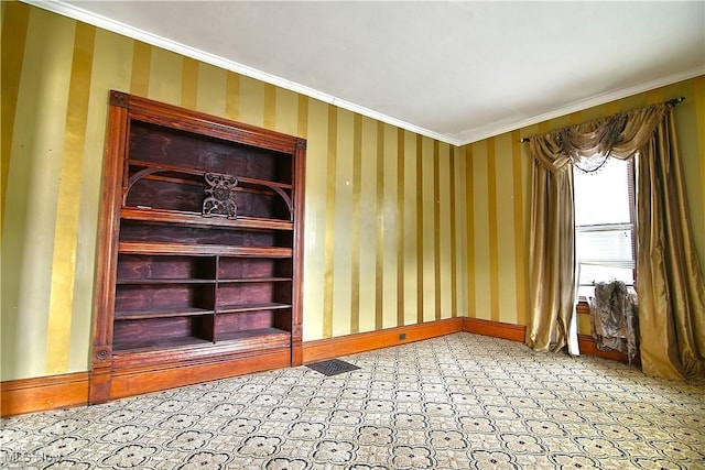 interior space featuring wallpapered walls, baseboards, visible vents, and ornamental molding