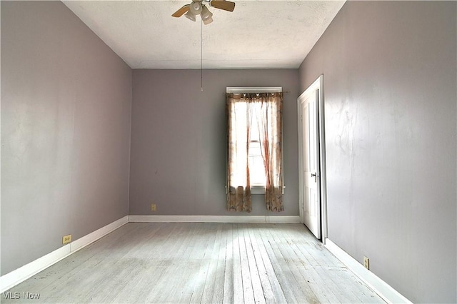 unfurnished room with light wood-style flooring, baseboards, and a ceiling fan