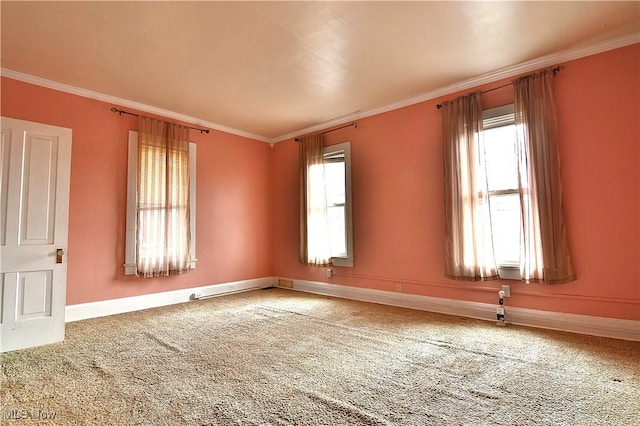 empty room featuring baseboards, carpet flooring, and crown molding