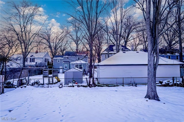 yard covered in snow featuring a residential view