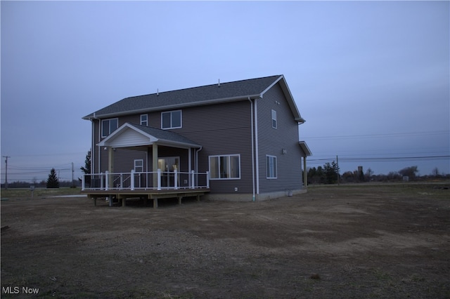 rear view of house featuring a deck