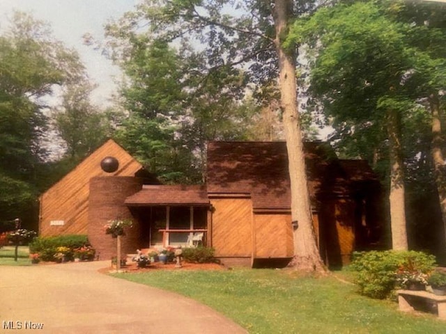 view of front of property with a porch and a front yard