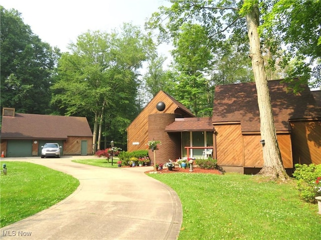 view of front of house with a garage, driveway, and a front yard