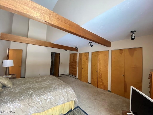 carpeted bedroom with beam ceiling and multiple closets