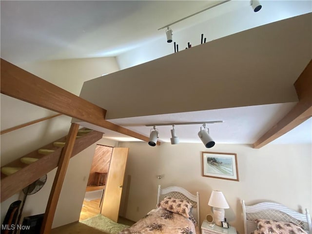 bedroom featuring lofted ceiling with beams