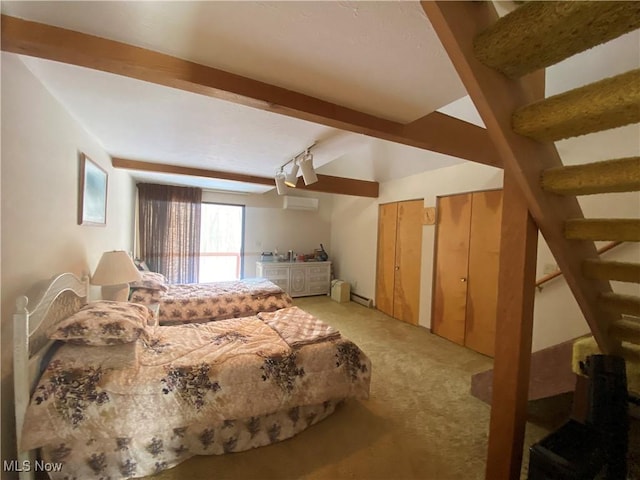 bedroom featuring beamed ceiling, carpet, a baseboard radiator, and multiple closets