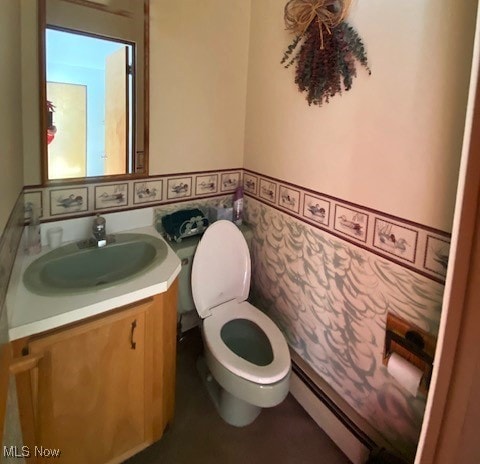 bathroom with toilet, a baseboard radiator, and vanity