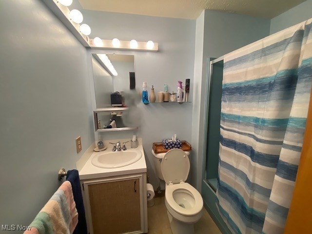 bathroom featuring shower / tub combo, vanity, and toilet