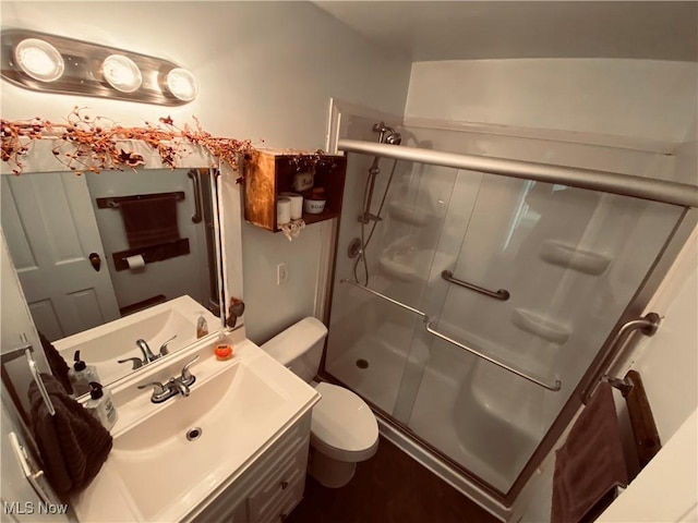 full bath with toilet, a shower stall, and vanity