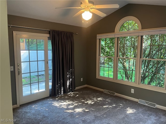 unfurnished room with lofted ceiling, carpet floors, visible vents, and baseboards