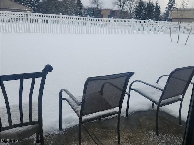 snow covered patio with fence