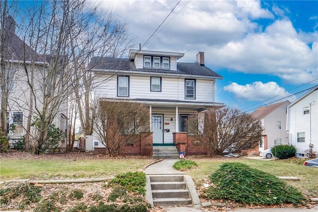 traditional style home with a front lawn and a chimney