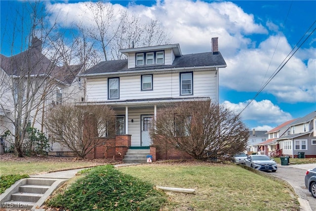 traditional style home featuring a front yard and a chimney