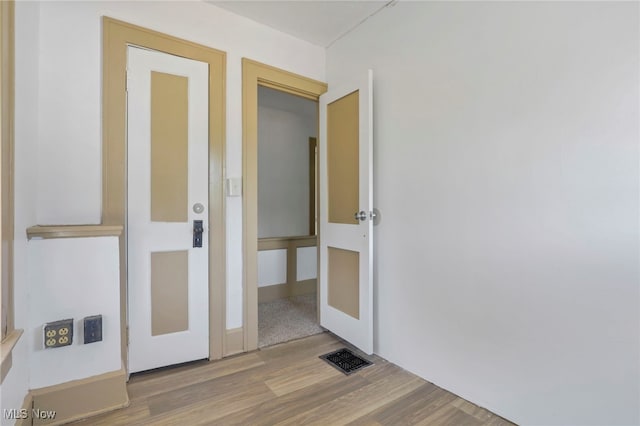 unfurnished room featuring visible vents and wood finished floors