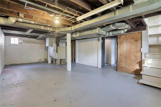 basement featuring heating unit and stairway