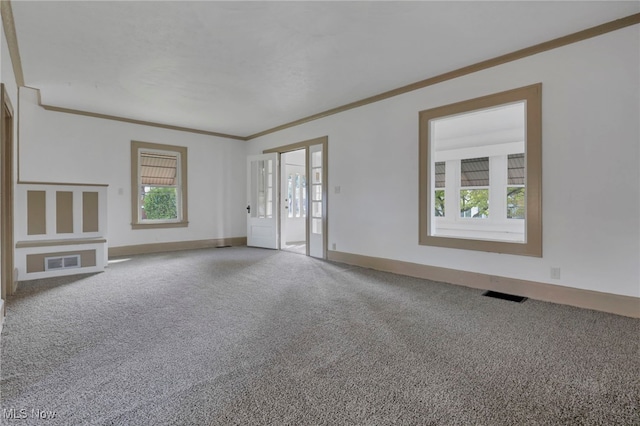 unfurnished living room featuring carpet floors, visible vents, and crown molding